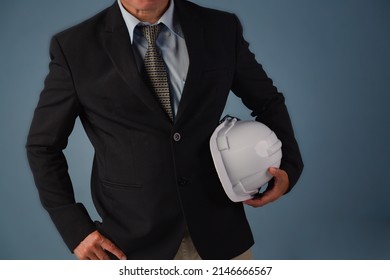 Handsome Business Man Engineer In Hard Hat Blue Color Background, Architect Man Holding Safety Hamlet. 