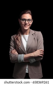 Handsome business woman isolated on black with arms crossed