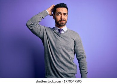 Handsome businessman with beard wearing casual tie standing over purple background confuse and wonder about question. Uncertain with doubt, thinking with hand on head. Pensive concept.