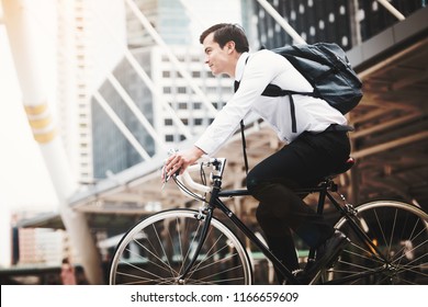 Handsome businessman caucasian wearing  white shirt with a necktie uniform in company employee using riding a bicycle work in the city, Concept healthy and ecology bike go to a work - Shutterstock ID 1166659609