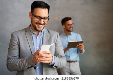 Handsome Businessman Checking Emails On The Phone In Modern Office In Coffee Break