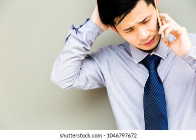 Handsome Businessman Gets Upset And Unsatisfied, His Customer Or Employee Cheats Him. Charming Man Talk To Customer, Employee By Using Mobile Phone. Attractive Asian Guy Feel Bored, Unhappy Copy Space