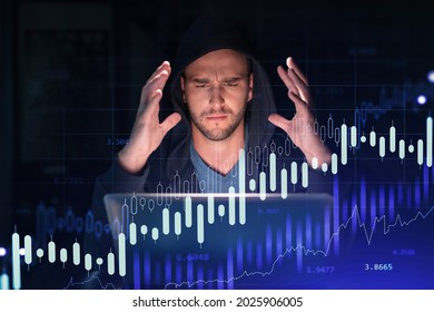 Handsome businessman in hoodie at workplace working with laptop to optimize trading strategy at corporate finance fund. Forex chart hologram over office background
