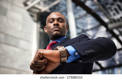 Handsome businessman looking at his watch - Powered by Shutterstock