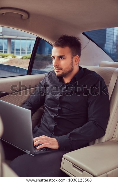 A handsome businessman\
in luxury car