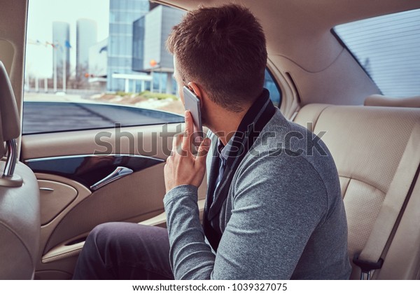 A handsome businessman\
in luxury car