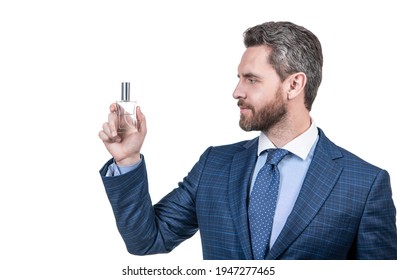 handsome businessman man in businesslike suit presenting male cosmetic product of mens perfume isolated on white, copy space, advert.