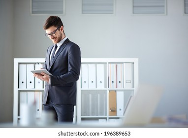 Handsome businessman networking in office - Powered by Shutterstock