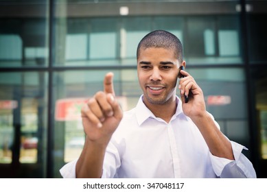 Handsome businessman pointing finger to camera, his face is in focus while his finger is out of focus. Shallow depth of field. - Powered by Shutterstock