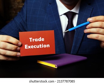 A Handsome Businessman Showing A Blank Piece Of Paper With Sign Trade Execution . Close-up Shot. Soft Focus.
