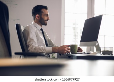 Handsome businessman solving his working problems indoors. Business concept - Shutterstock ID 1686979927