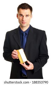 Handsome businessman in suit standing holds gold brick