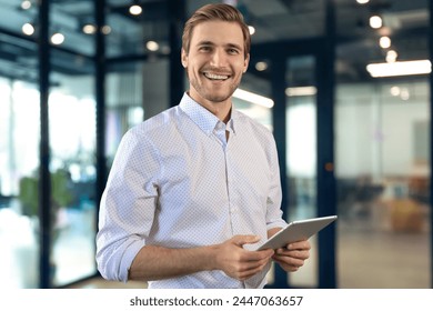 Handsome businessman using his tablet in the office