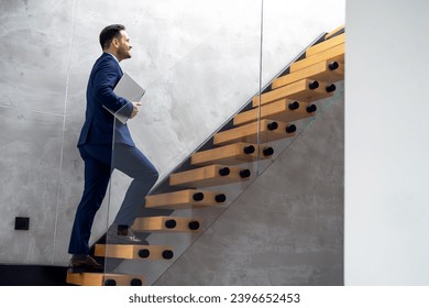 Handsome businessman walking up stairs - Powered by Shutterstock