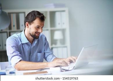 Handsome Businessman Working With Laptop In Office