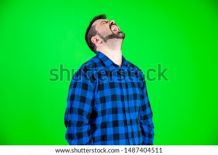 Handsome caucasian guy making really funny expressions with blue shirt