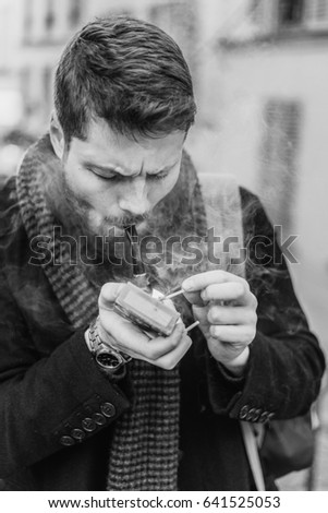Handsome caucasian male smoking pipe. 