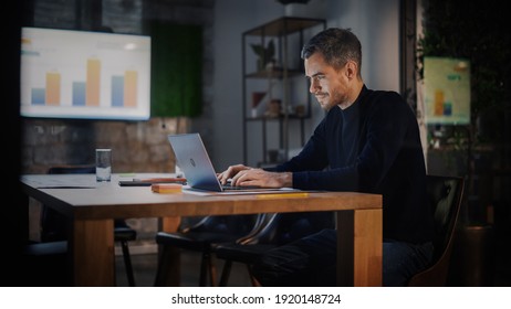 Handsome Caucasian Male is Working on Laptop Computer while Sitting Behind a Conference Table in Meeting Room in an Creative Agency. Project Manager is Busy With Business Strategy and Development. - Powered by Shutterstock