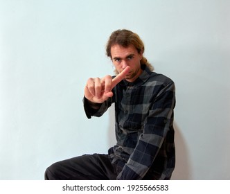 A Handsome Caucasian Man Showing ONE With His Finger Asking For A Minute On A White Background