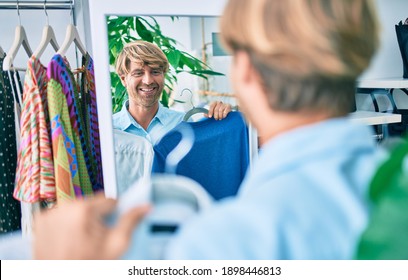 Handsome Caucasian Man Smiling Happy Shopping On Retail Shop At The Shopping Center Trying On Clothes