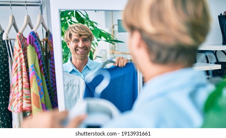 Handsome Caucasian Man Smiling Happy Shopping On Retail Shop At The Shopping Center Trying On Clothes