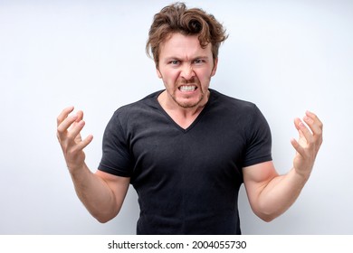 handsome caucasian man standing over isolated white background angry and mad raising fists frustrated and furious while shouting with anger. Rage and aggressive concept. Copy space. Close-up portrait - Shutterstock ID 2004055730