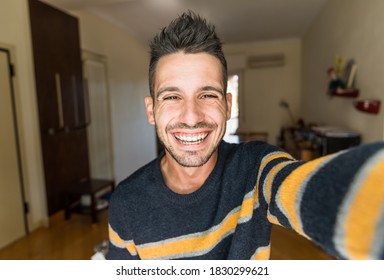 Handsome Caucasian Man Taking A Selfie Portrait Indoor At Home - Happy Guy Smiling At The Camera.