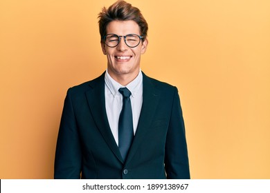 Handsome caucasian man wearing business suit and tie with a happy and cool smile on face. lucky person. 