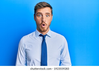 Handsome Caucasian Man Wearing Business Shirt And Tie Scared And Amazed With Open Mouth For Surprise, Disbelief Face 