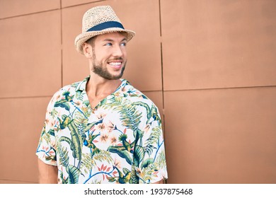 Handsome Caucasian Man Wearing Summer Hat And Flowers Shirt Smiling Happy Outdoors