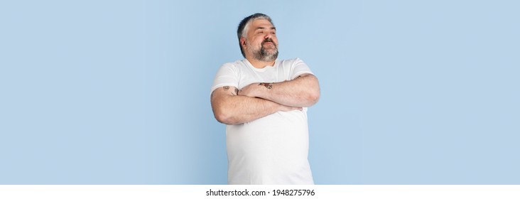 Handsome Caucasian Plus Size Male Model Isolated On Blue Studio Background. Concept Of Inclusion, Human Emotions, Facial Expression