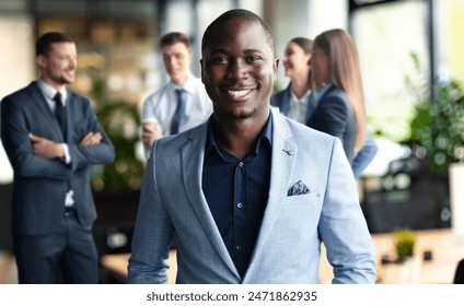 Handsome cheerful african american executive business man at the workspace office - Powered by Shutterstock