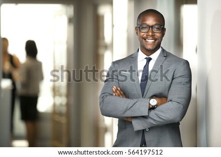 Handsome cheerful african american executive business man at the workspace office 