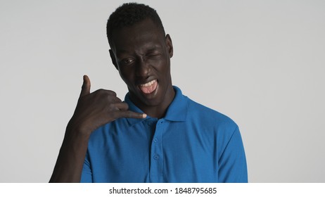 Handsome Cheerful African American Guy Keep Hands Near Face Showing Call Me Gesture On Camera Isolated On White Background. Phone Gesture