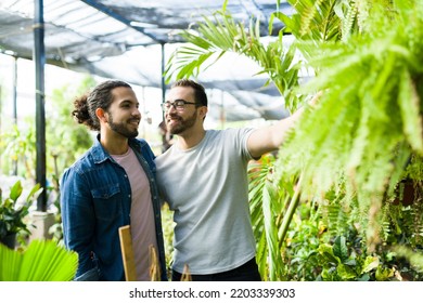 Handsome Cheerful Caucasian Man Hugging His Gay Partner While Buying Together Plants At The Nursery Garden