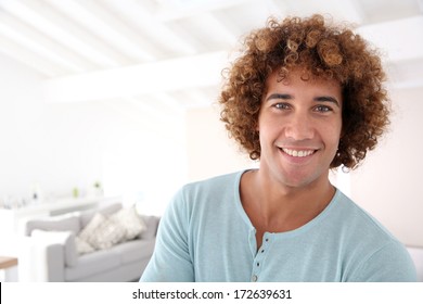 Handsome cheerful man standing in new home
