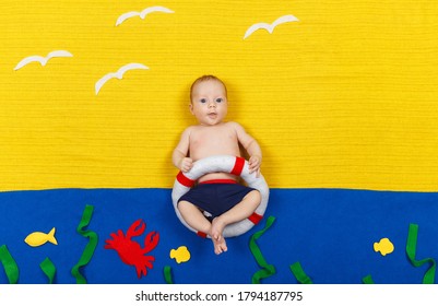 Handsome Child Imitating Swimming And Jumping Into The Water. Pretty Kid Is Diving Into Imaginary Pool. Adorable Baby Boy Lying In Blue Floor. Activity Child. Summer Vacation And Travel Concept