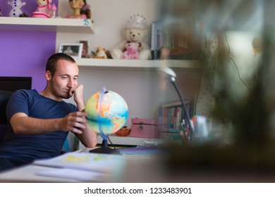 Handsome College Student Studing At Home For His Geography Exam 