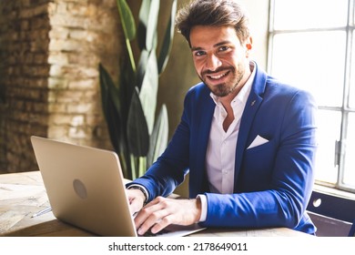 Handsome And Confident Young Business Man Working On Laptop In A Old Fashioned Office