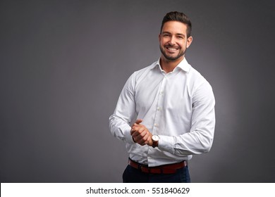 A Handsome Confident Young Man Standing And Smiling In A White Shirt.
