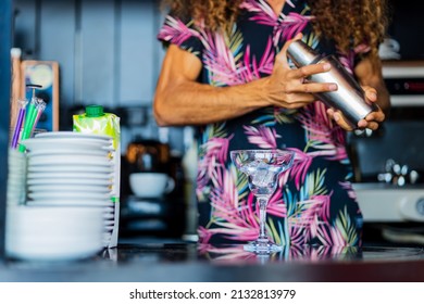 Handsome curly hair bartender preparing cocktail at the resort bar
