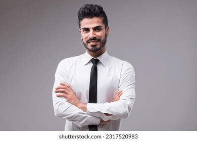 A handsome dark-skinned man in a white shirt, black tie. His well-groomed beard and friendly reassuring smile, both attractive and neat. Competence is an added bonus - Powered by Shutterstock