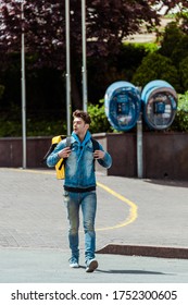 Handsome Delivery Man With Thermo Backpack Walking On Urban Street