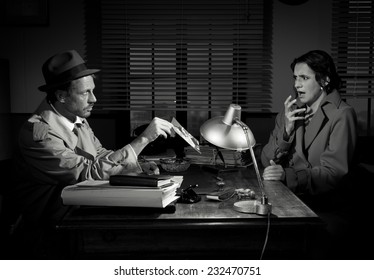 Handsome Detective At Office Desk Showing A Picture To A Young Woman, Film Noir Scene.