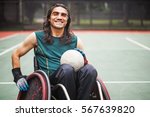 handsome determined disabled rugby player in a wheelchair on a stadium 