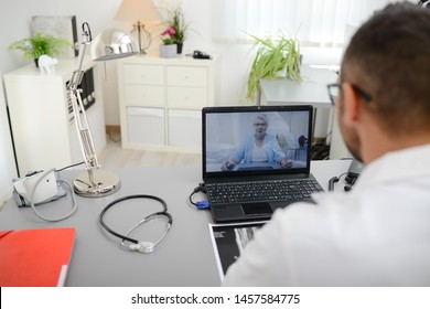 Handsome Doctor Giving A Remote Medical Consultation With Senior Woman Patient Over Internet Computer Telemedecine Diagnostic