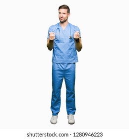 Handsome Doctor Man Wearing Medical Uniform Over Isolated Background Doing Money Gesture With Hand, Asking For Salary Payment, Millionaire Business