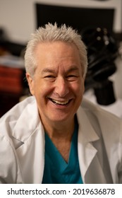 Handsome Doctor Smiling At Camera In Office Setting