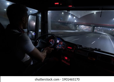 Handsome Driver At The Wheel Of A Truck At Night.