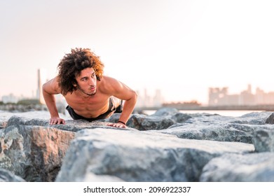 Handsome Egyptian man doing pushups exercise outdoors